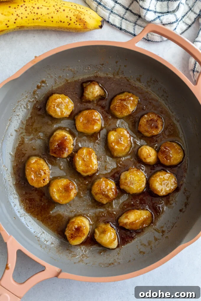 How to Make Perfect Caramelized Bananas for Desserts and Toppings 4 pan-fried bananas cooking in a skillet