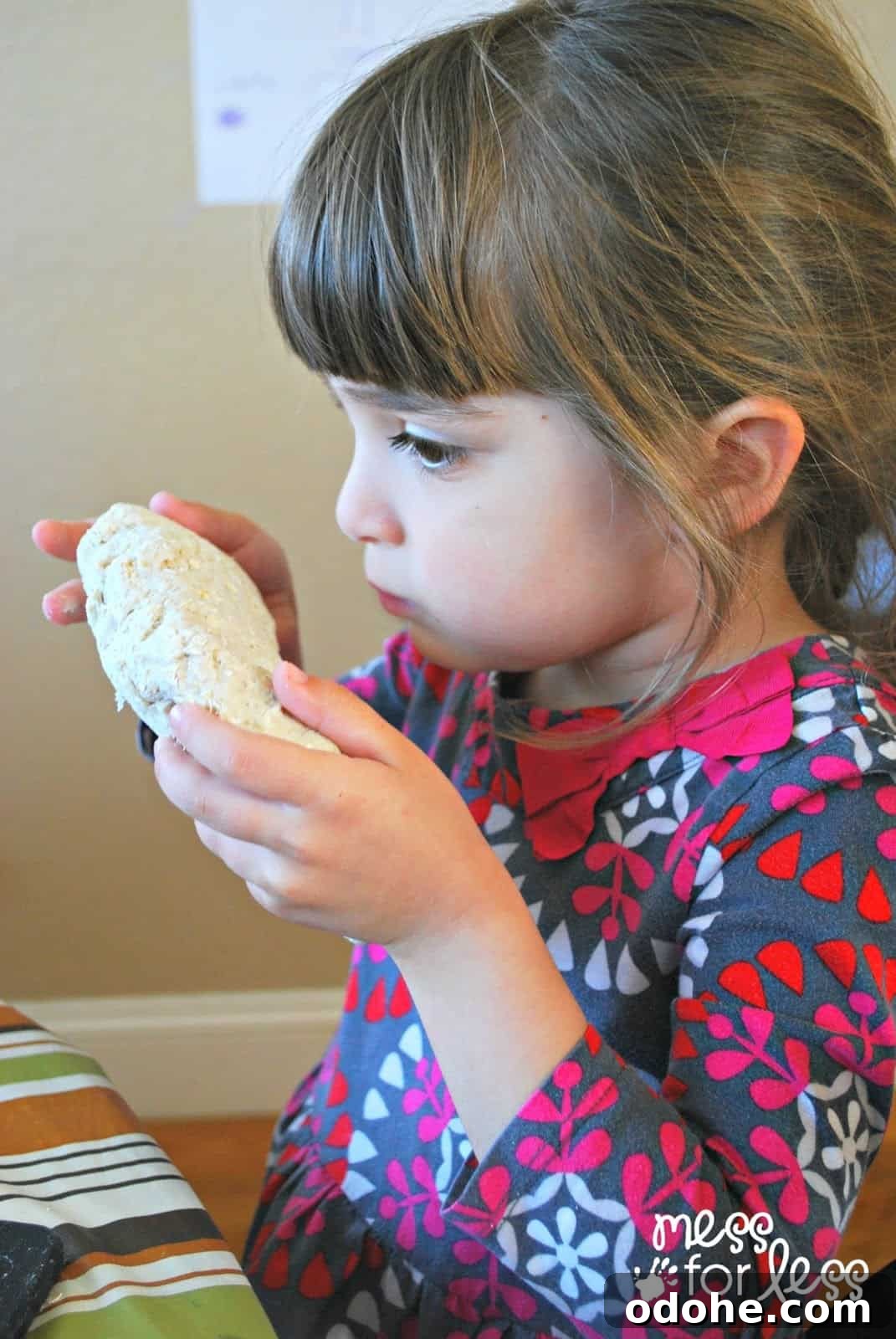 child smelling playdough