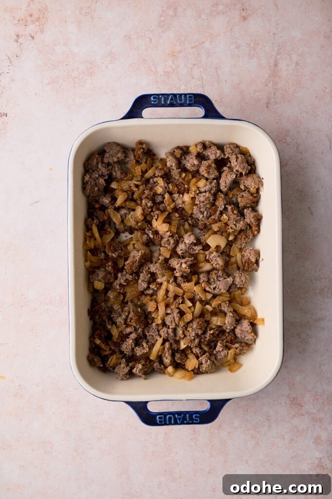 Tater Tot Breakfast Casserole Recipe for Brunch Crowd 4 The sausage is added to the baking dish.