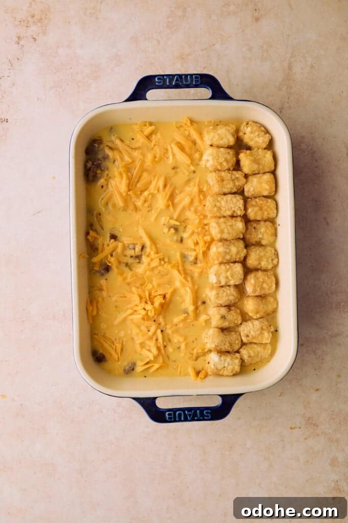 Tater Tot Breakfast Casserole Recipe for Brunch Crowd 8 Two lines of tater tots are lined up on top of the egg mixture.