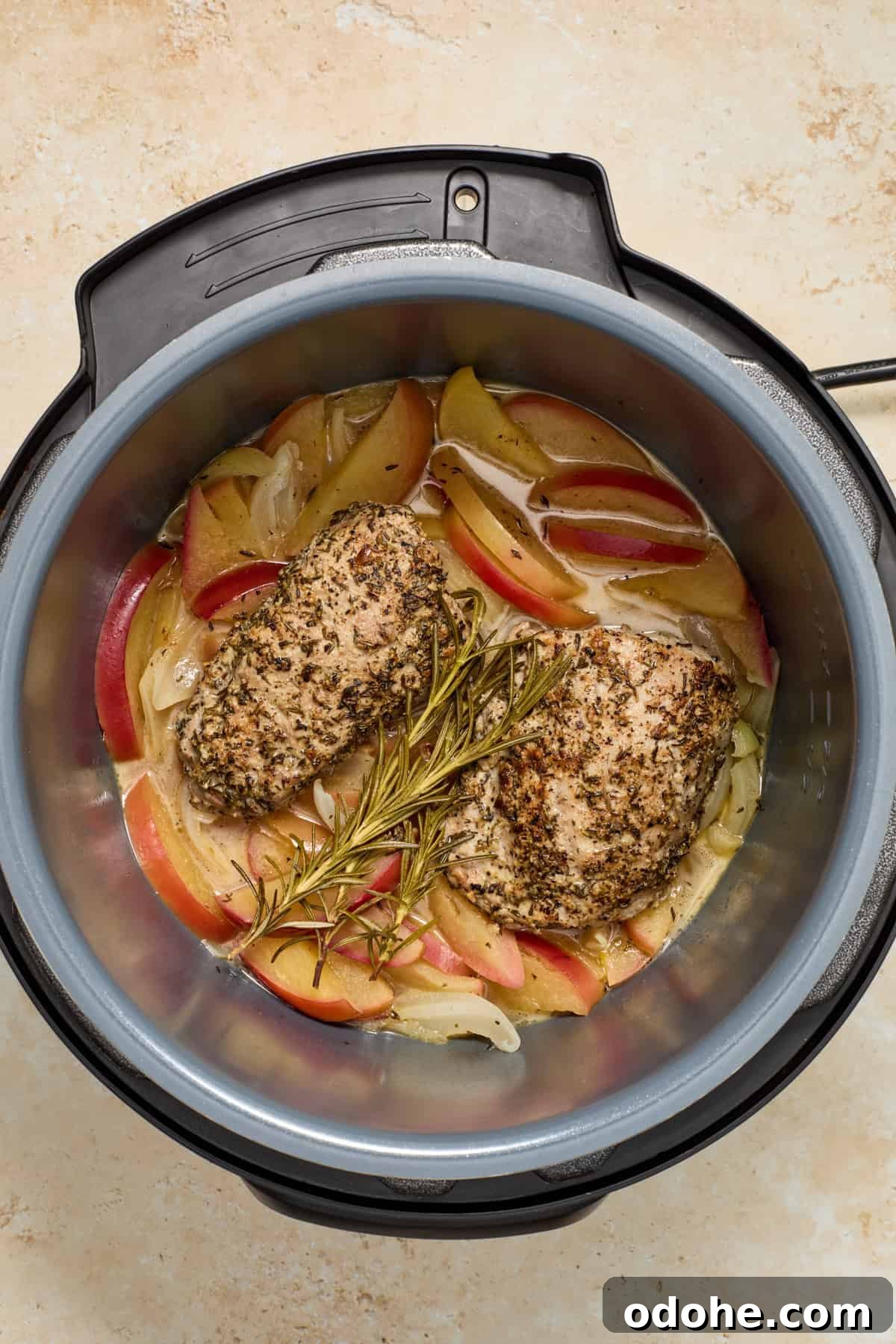 Perfect Instant Pot Pork Tenderloin Recipe for Juicy Results 11 Cooked pork tenderloin and apples in Instant pot pressure cooker.