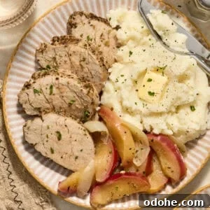Perfect Instant Pot Pork Tenderloin Recipe for Juicy Results 14 Pork tenderloin sliced on plate with apples and mashed potatoes.