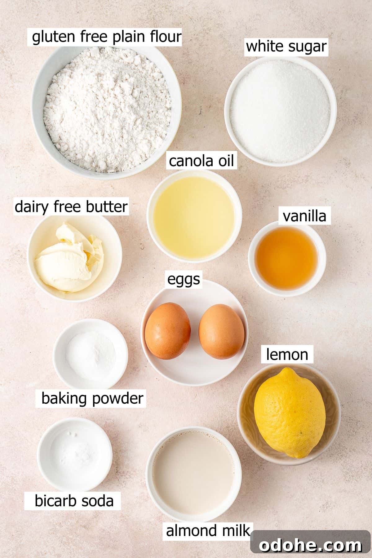 All ingredients needed to make gluten free lemon cupcakes laid out in bowls.