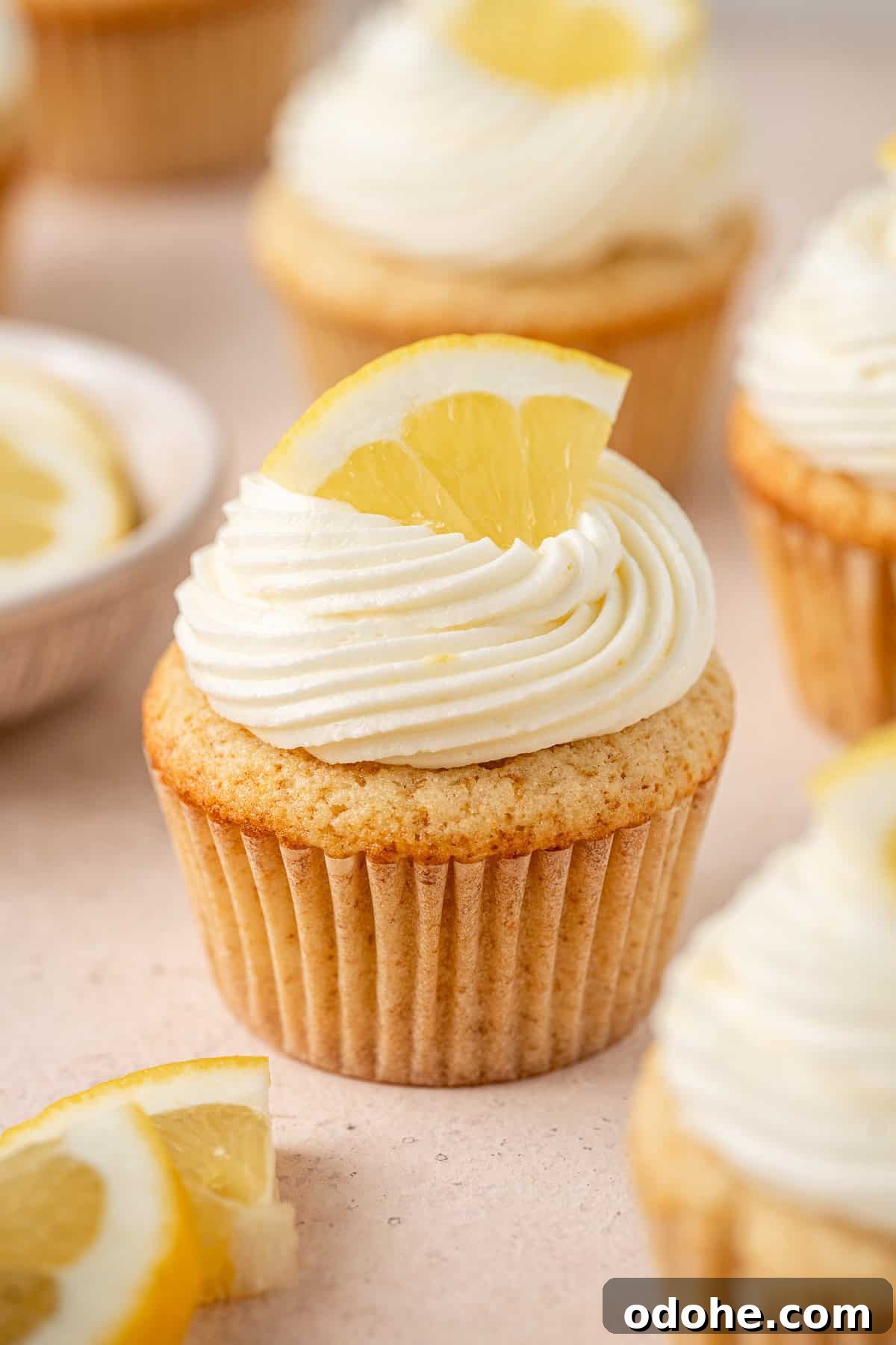 Close up of a gluten and dairy free lemon cupcake with buttercream frosting.