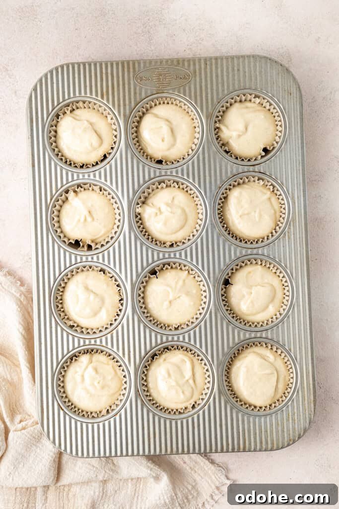 The gluten free lemon cupcake batter in a muffin tin ready to be baked.