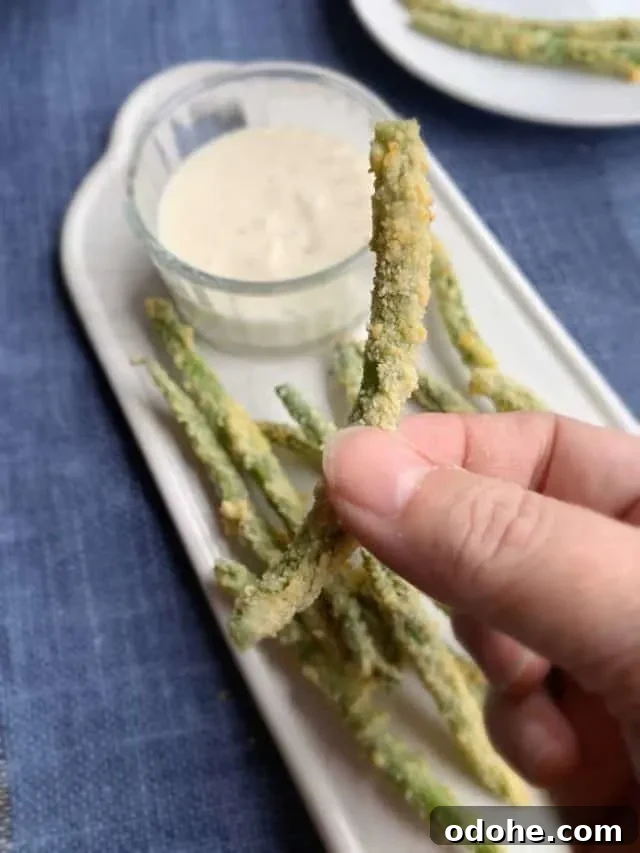 holding one green bean fry