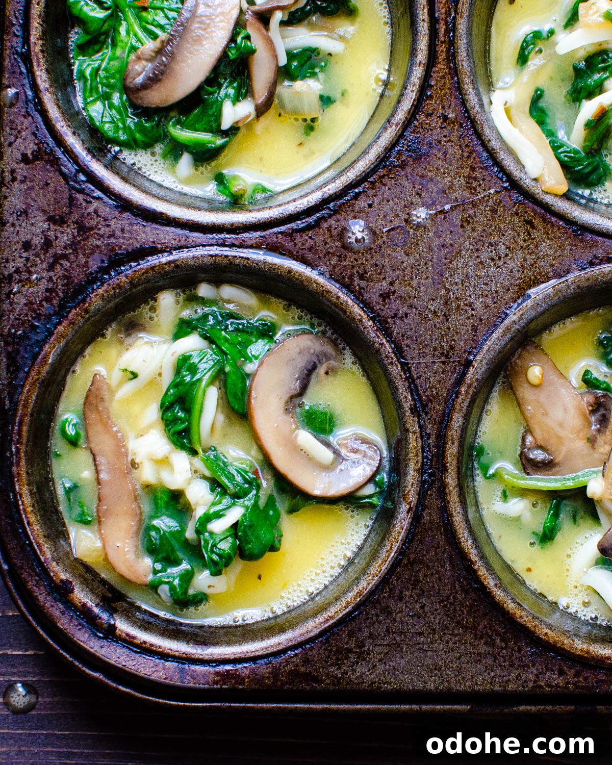 Spinach and Mushroom Mini Frittatas for Quick Breakfasts 6 Filling the muffin tins with egg and vegetable mixture.