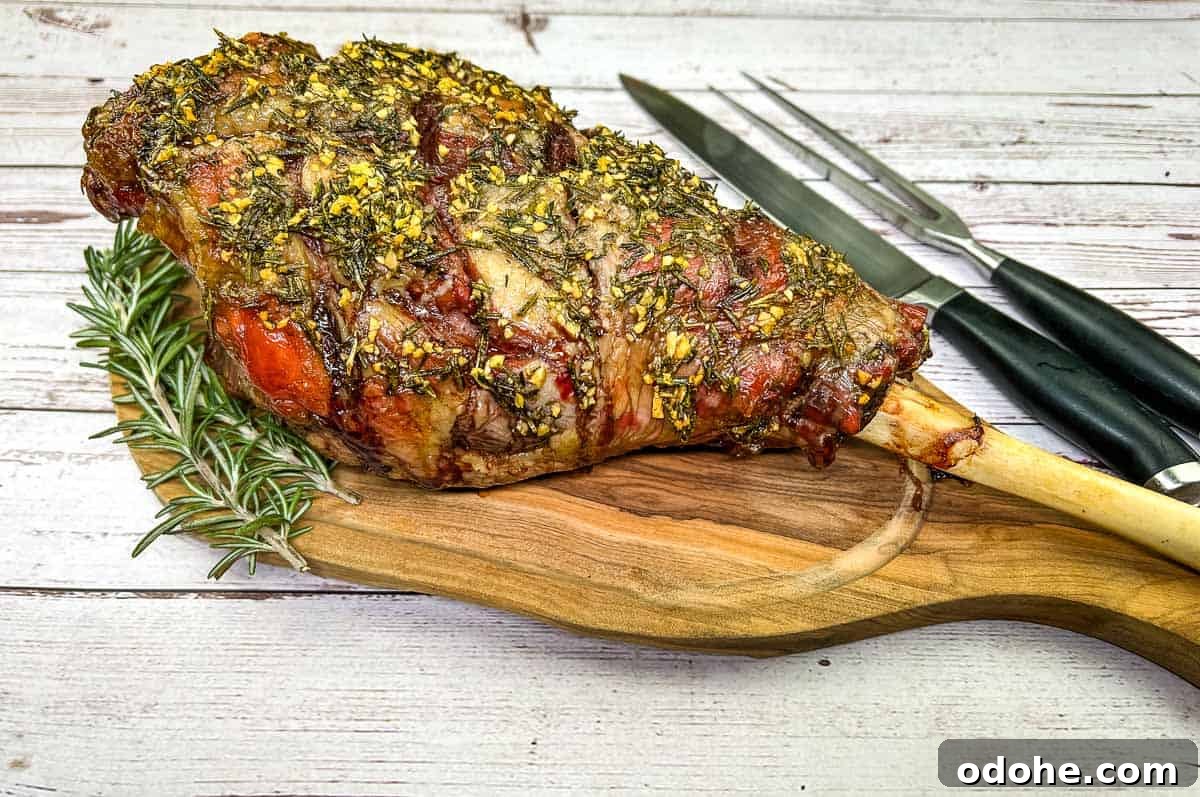 31 Memorial Day Recipes to Start Cookout Season Right 31 Whole cooked leg of lamb on a board with a knife.