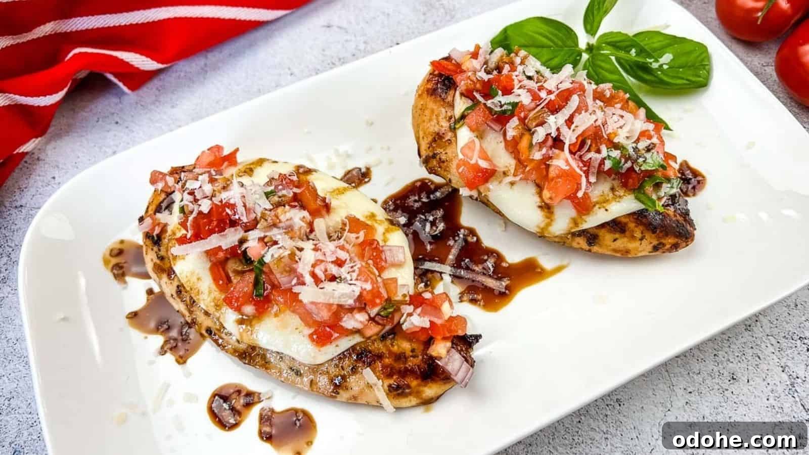 31 Memorial Day Recipes to Start Cookout Season Right 7 Grilled Bruschetta Chicken on a white plate.