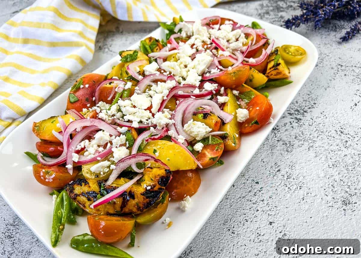 31 Memorial Day Recipes to Start Cookout Season Right 9 A plate with Grilled Peach Salad with Tomatoes.