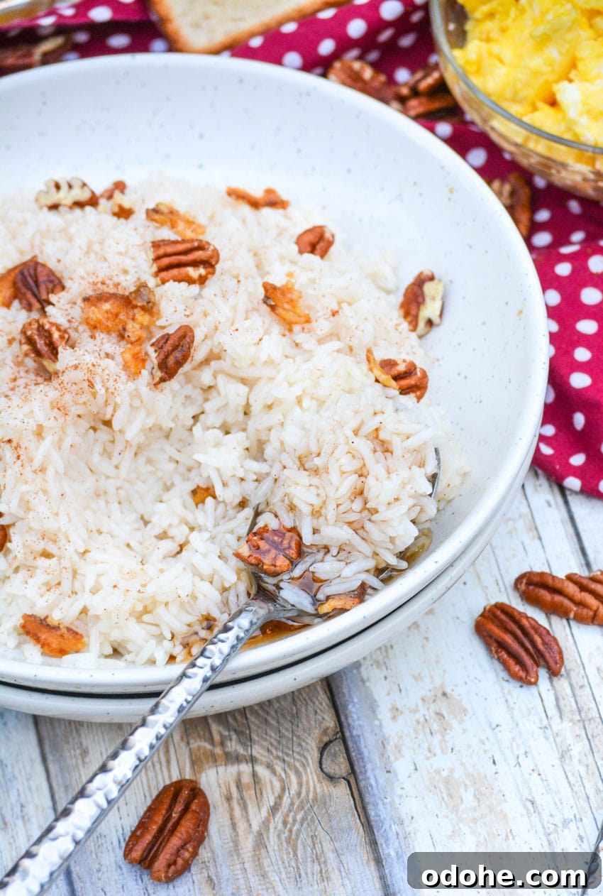 a silver spoon digging into a white bowl filled with breakfast rice