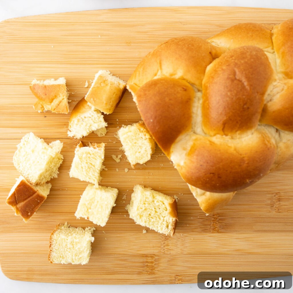 challah bread cut into cubes on cutting board