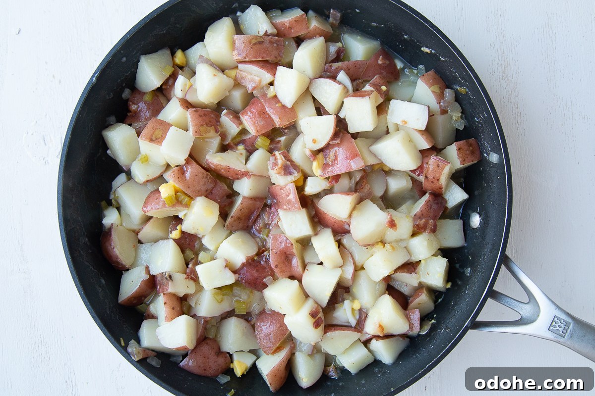 Authentic German Potato Salad with Hard-Boiled Eggs & Bacon 10 german potato salad in a nonstick skillet
