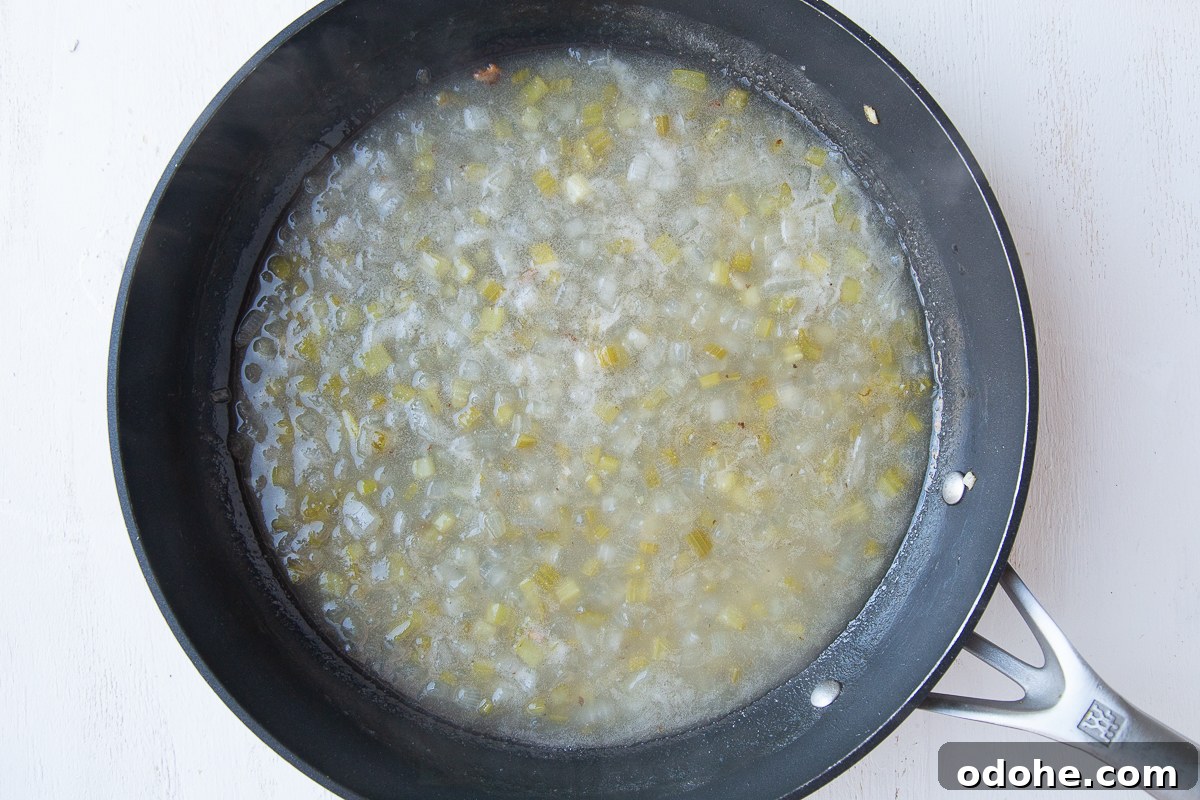 Authentic German Potato Salad with Hard-Boiled Eggs & Bacon 9 dressing for german potato salad, cooking in a skillet