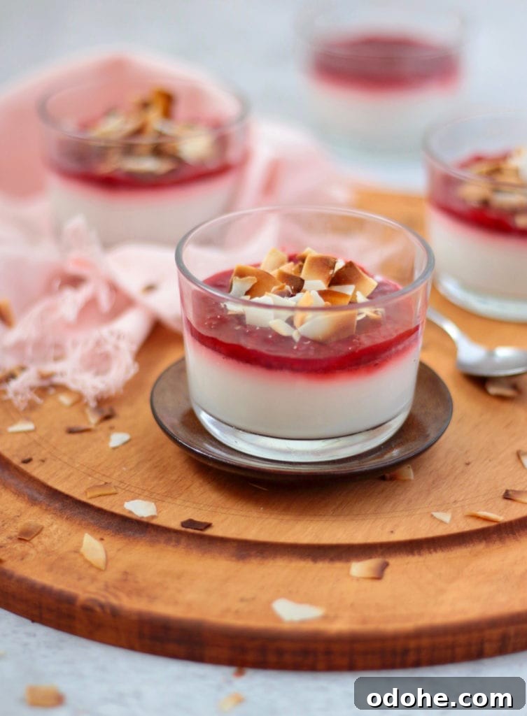 Vegan Coconut Panna Cotta with Fresh Strawberries 3 One panna cotta over a small brown plate and a wooden board