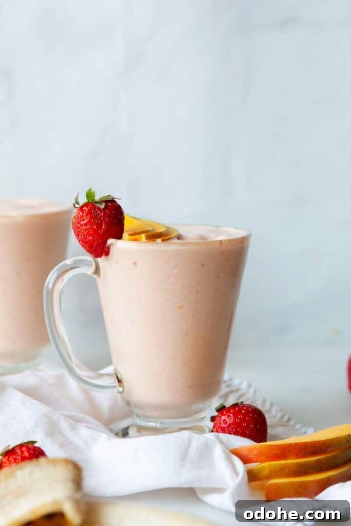 Creamy Banana, Mango & Strawberry Smoothie Recipe 3 mango strawberry and banana smoothie in a glass before serving