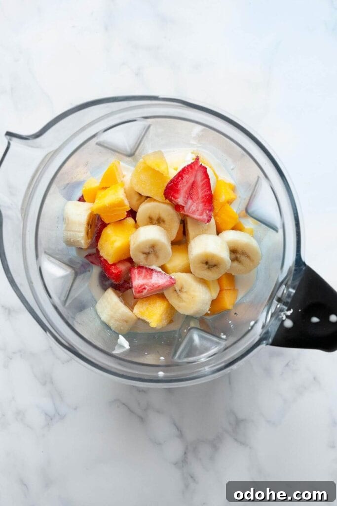 Creamy Banana, Mango & Strawberry Smoothie Recipe 5 all ingredients in a blender before blending