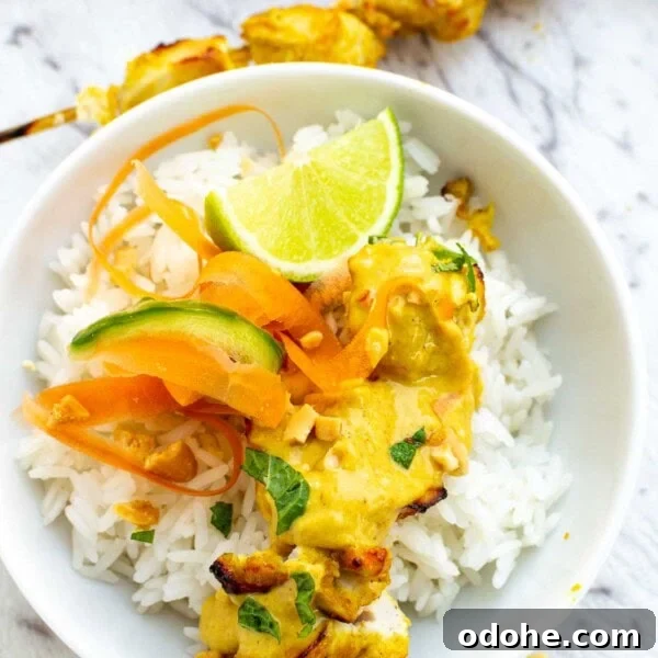 Spicy Thai Peanut Chicken Thighs with Sticky Glaze 9 A white bowl of satay chicken with peanut sauce