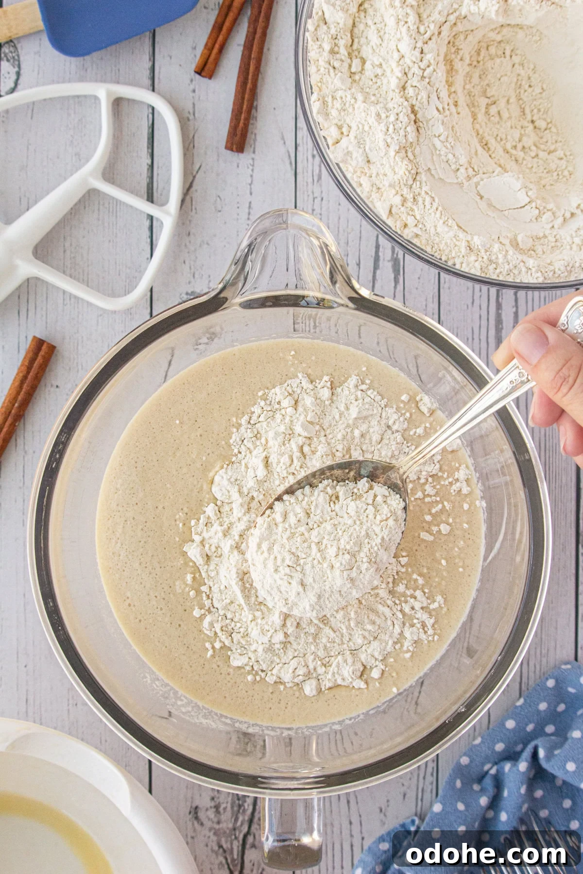 Giant Texas-Style Cinnamon Rolls: Soft, Gooey, Oversized Treat 5 Flour being sprinkled over yeast.