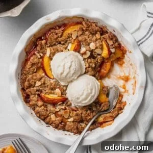 Gluten-Free Peach Crisp with Oats & Almonds — Simple Summer Dessert 8 Gluten free peach crisp in white pie dish.