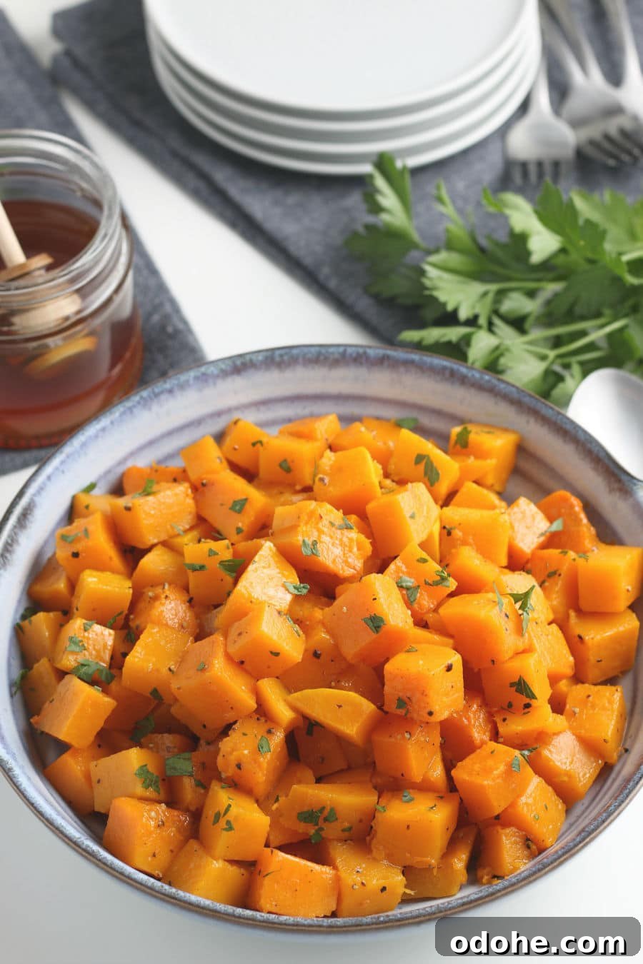 Roasting a Whole Butternut Squash: Simple Oven Method 2 Roasted butternut squash cubes with parsley in a serving bowl.