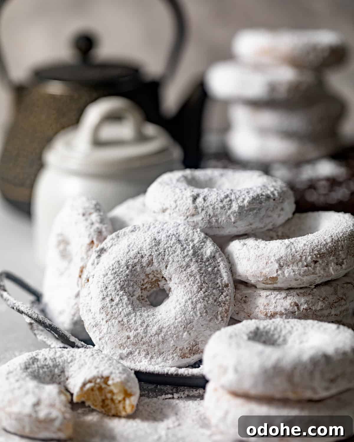 Powdered Sugar Donuts Recipe: Light, Fluffy Homemade Donuts 2 powdered sugar donuts stacked on top of each other.