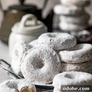 Powdered Sugar Donuts Recipe: Light, Fluffy Homemade Donuts 9 powdered sugar donuts stacked on top of each other.