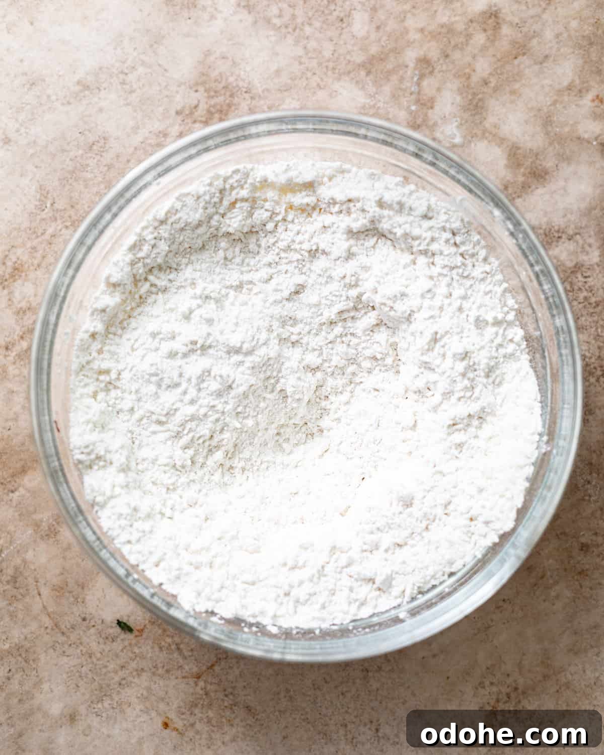 Powdered Sugar Donuts Recipe: Light, Fluffy Homemade Donuts 4 cake flour, nutmeg, cardamom, salt, baking powder, and baking soda whisked together in a bowl.