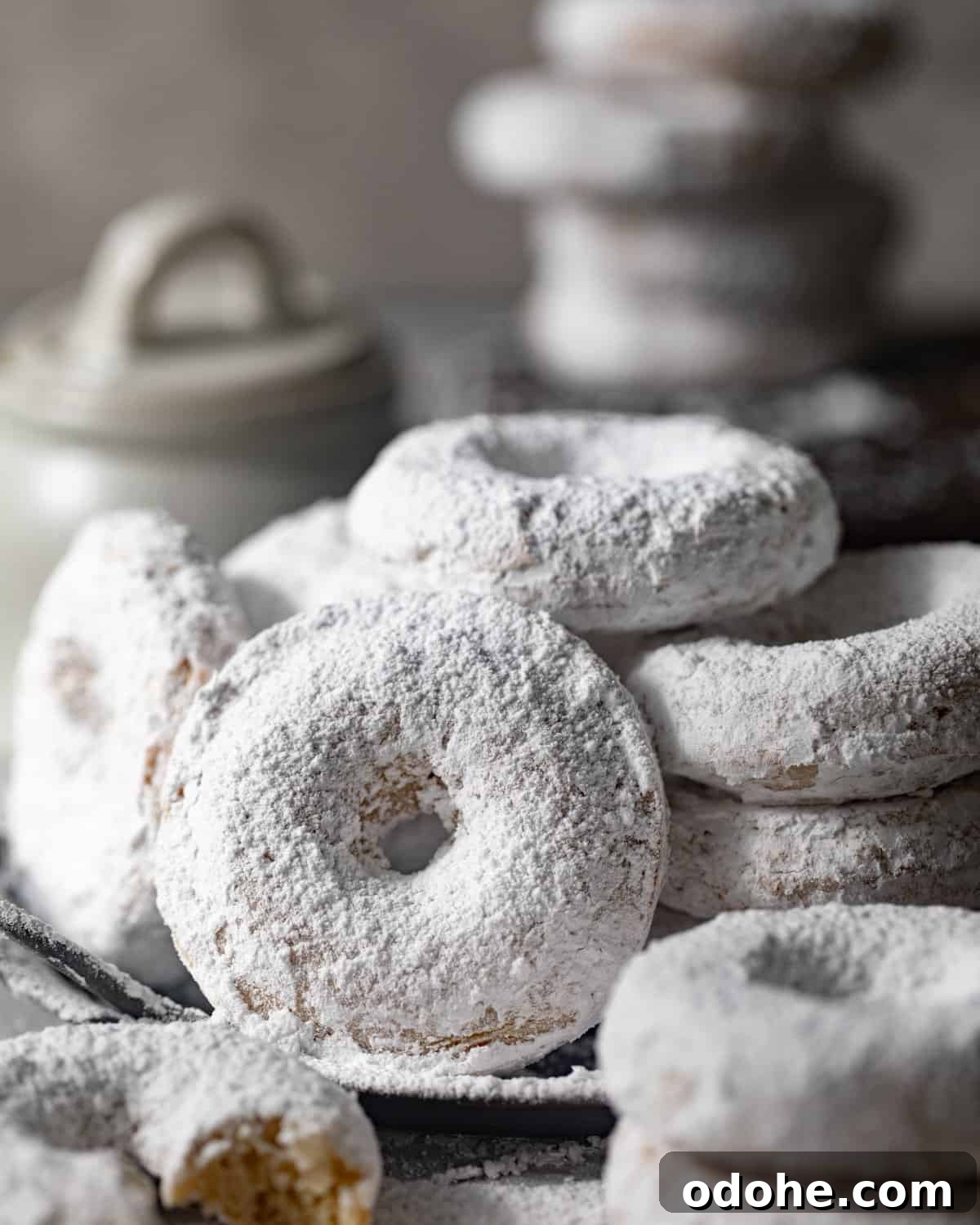 Powdered Sugar Donuts Recipe: Light, Fluffy Homemade Donuts 8 powdered donuts on a tray.