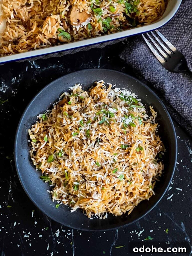 Basmati rice risotto (stick of butter rice) in a dark bowl.