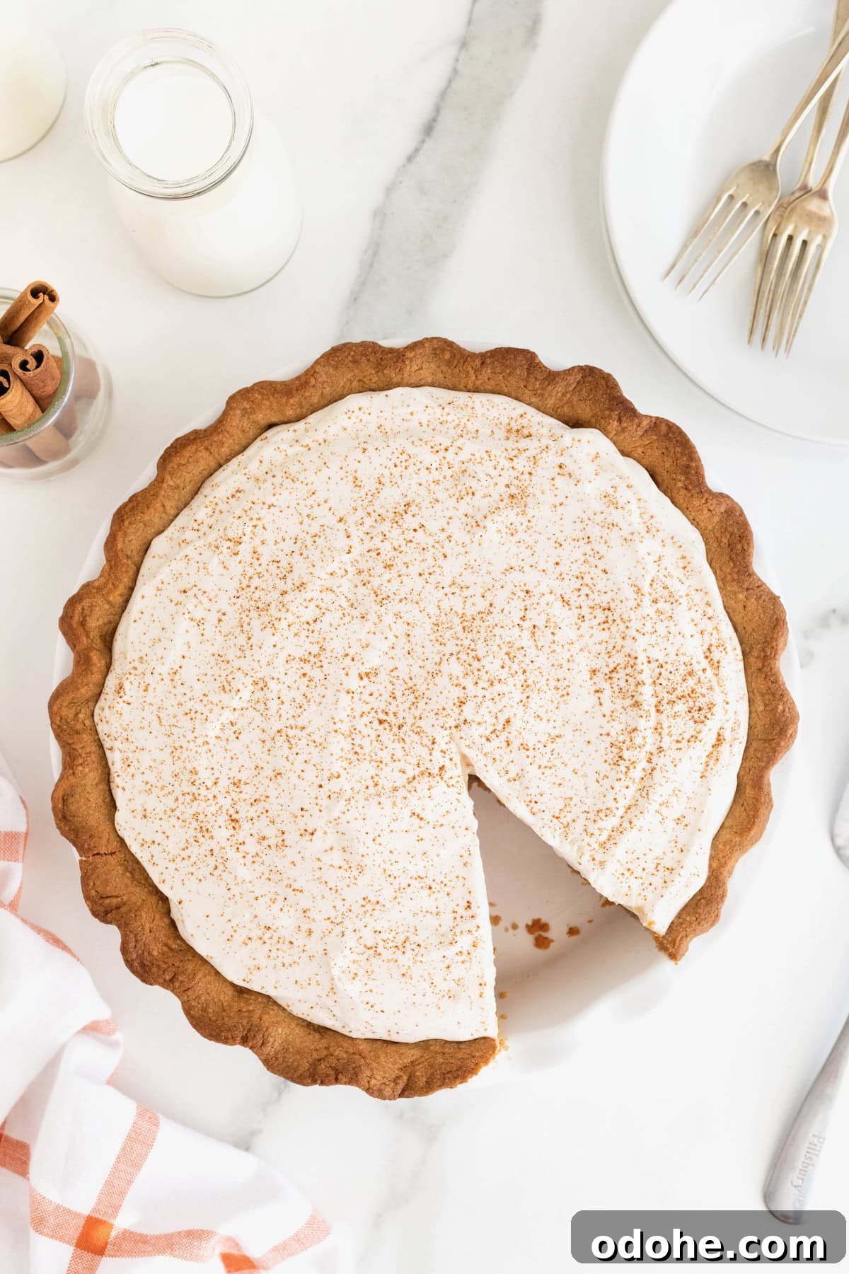 Creamy Pumpkin Pie Recipe: Classic Autumn Dessert Guide 3 A pumpkin cream pie with a slice out of it.