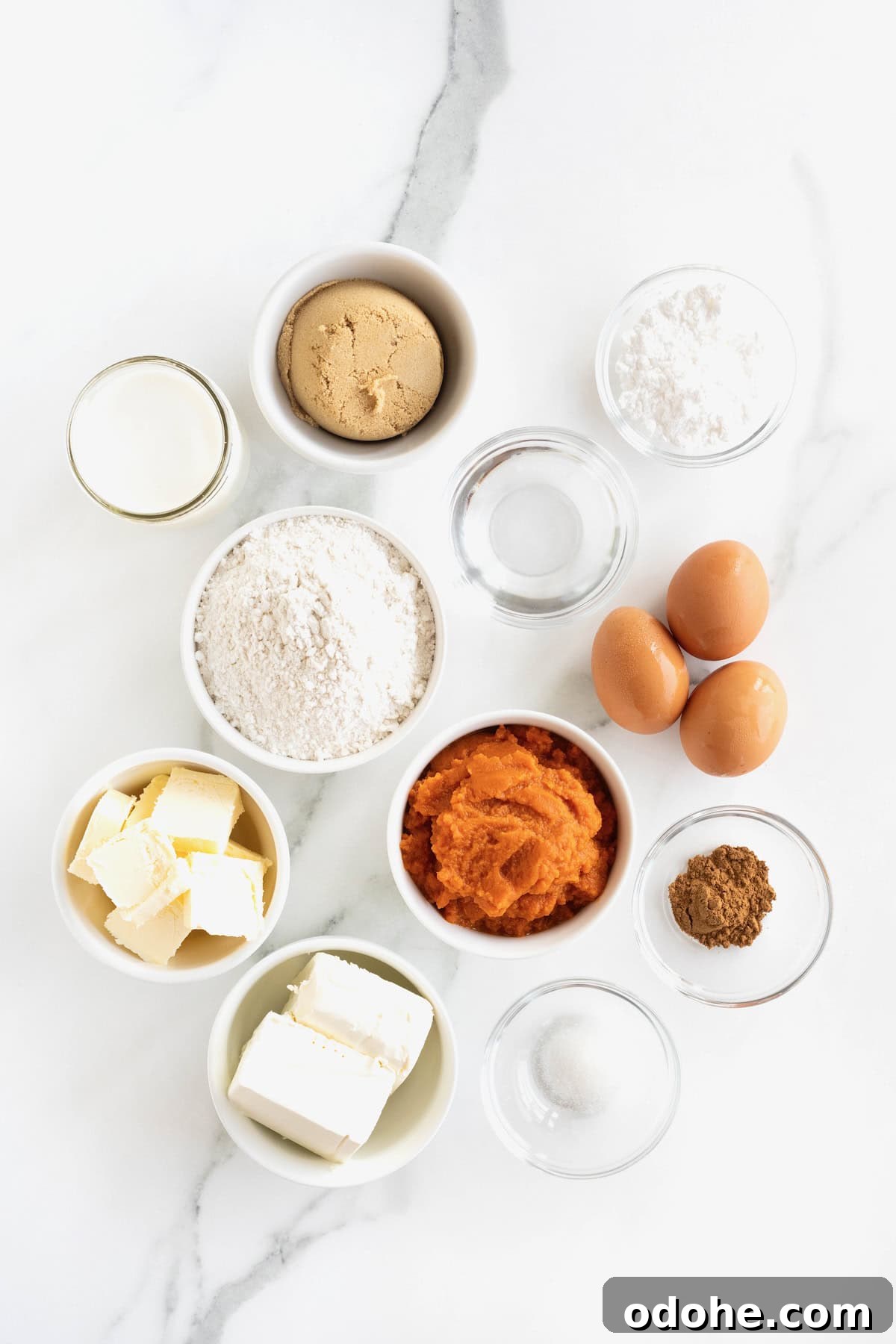 Creamy Pumpkin Pie Recipe: Classic Autumn Dessert Guide 6 Ingredients to make a pumpkin cream pie in small glass dishes on a white marble counter.
