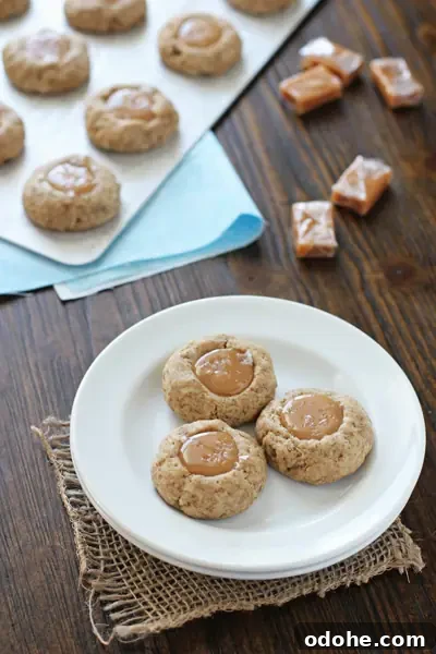 A white plate with three Caramel Latte Thumbprint Cookies.