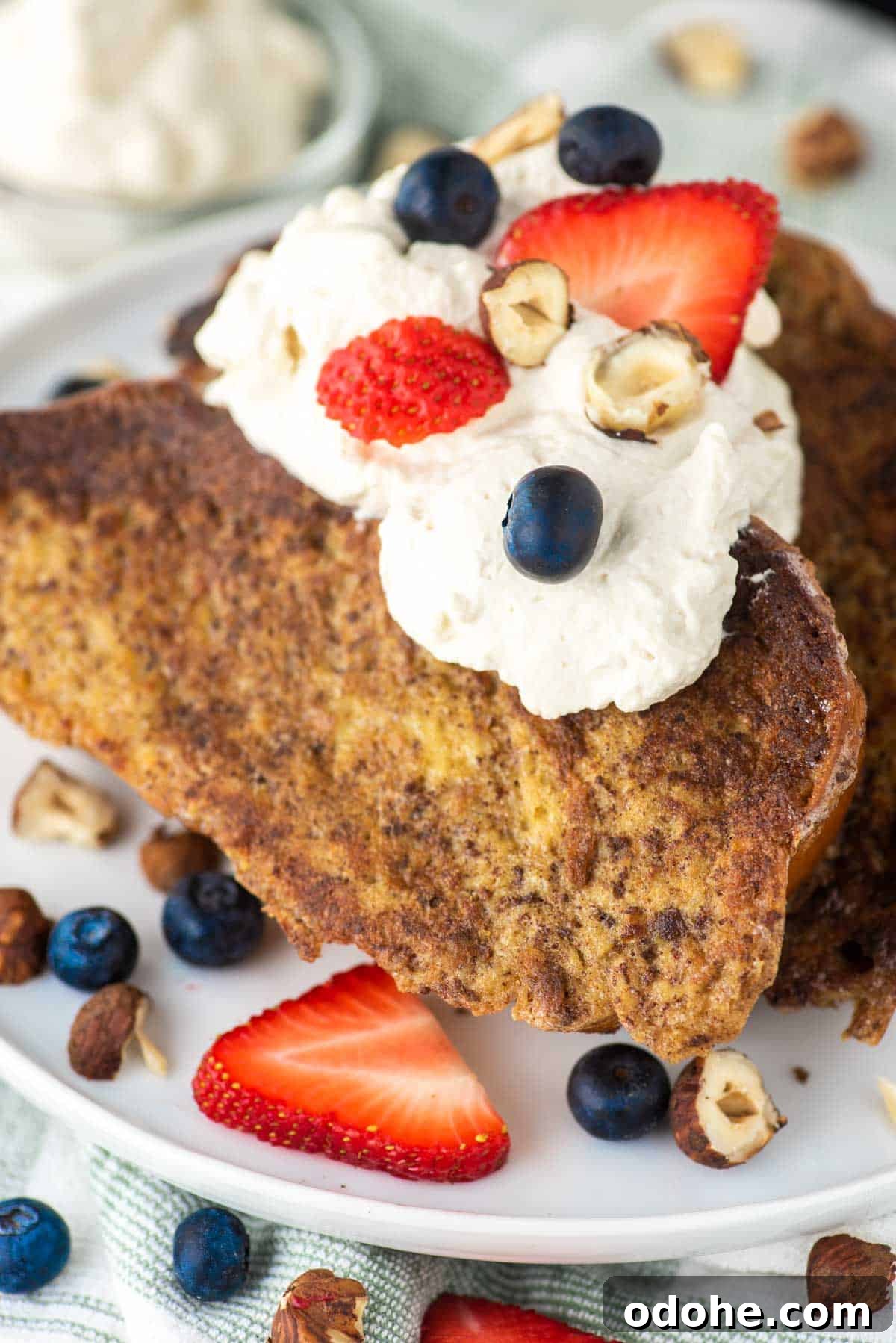 Baileys-Infused French Toast Recipe for Adults 2 Two slices of Baileys French toast on white plate.