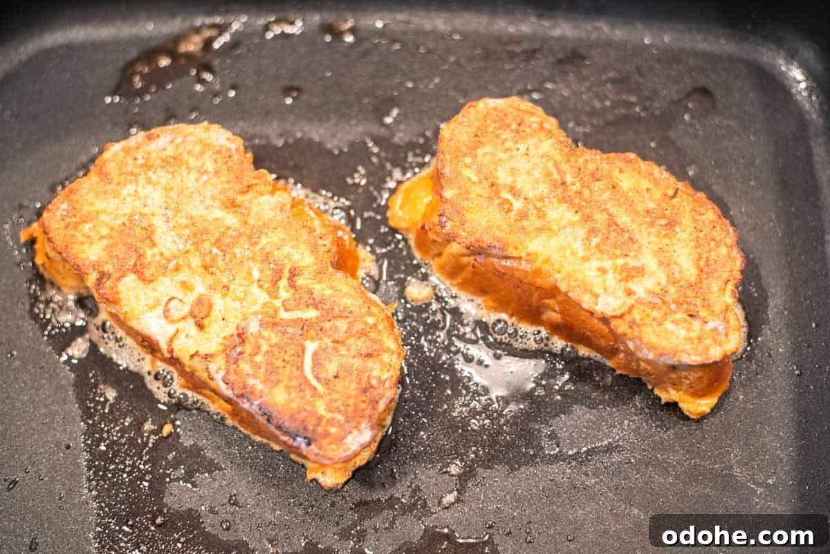 Baileys-Infused French Toast Recipe for Adults 6 French toast being cooked in skillet.