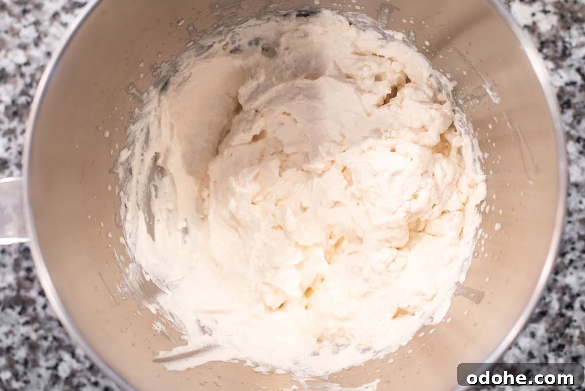 Baileys-Infused French Toast Recipe for Adults 7 Whipped cream in metal bowl.