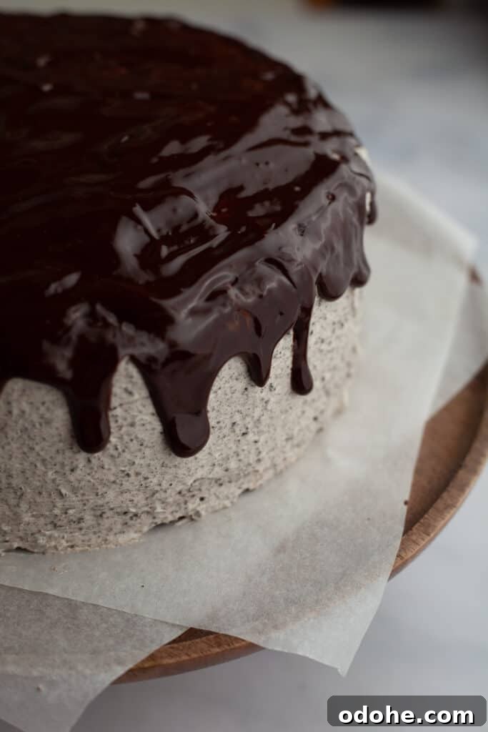 A close up of an oreo cake and a chocolate drip