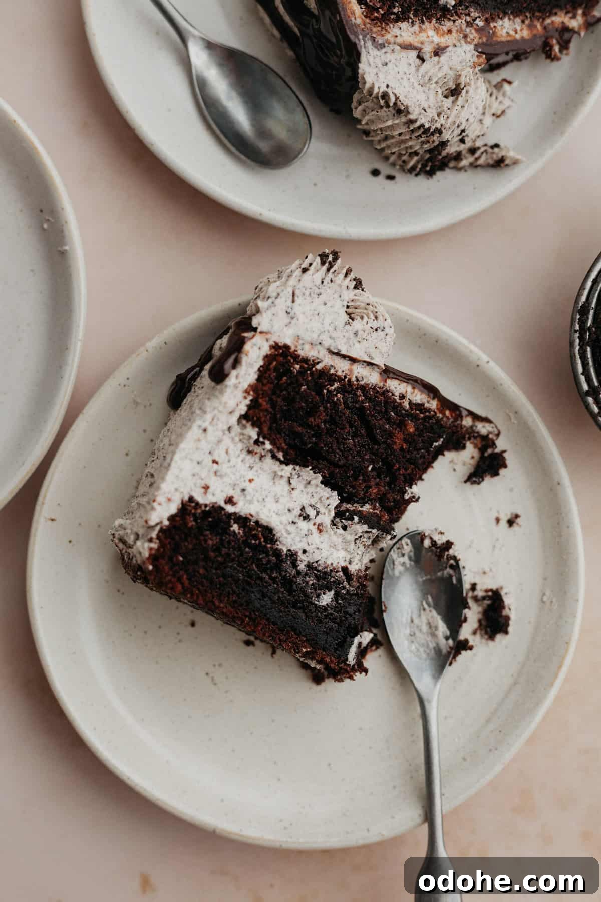 three plates of oreo drip cake slices on them