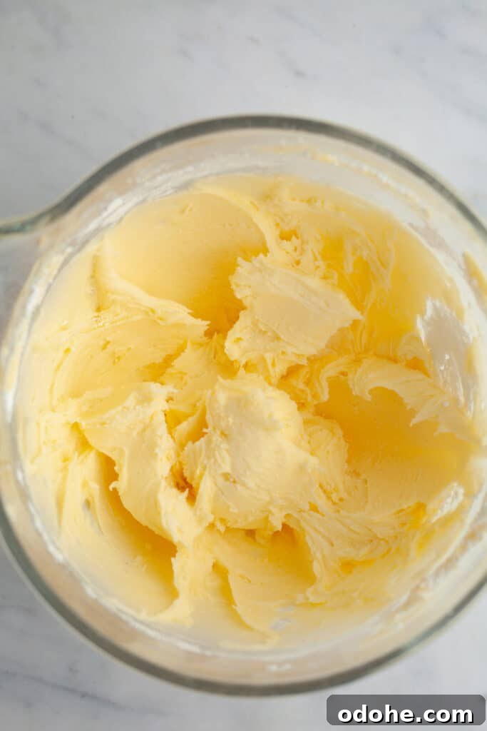 cream butter in a glass mixing bowl