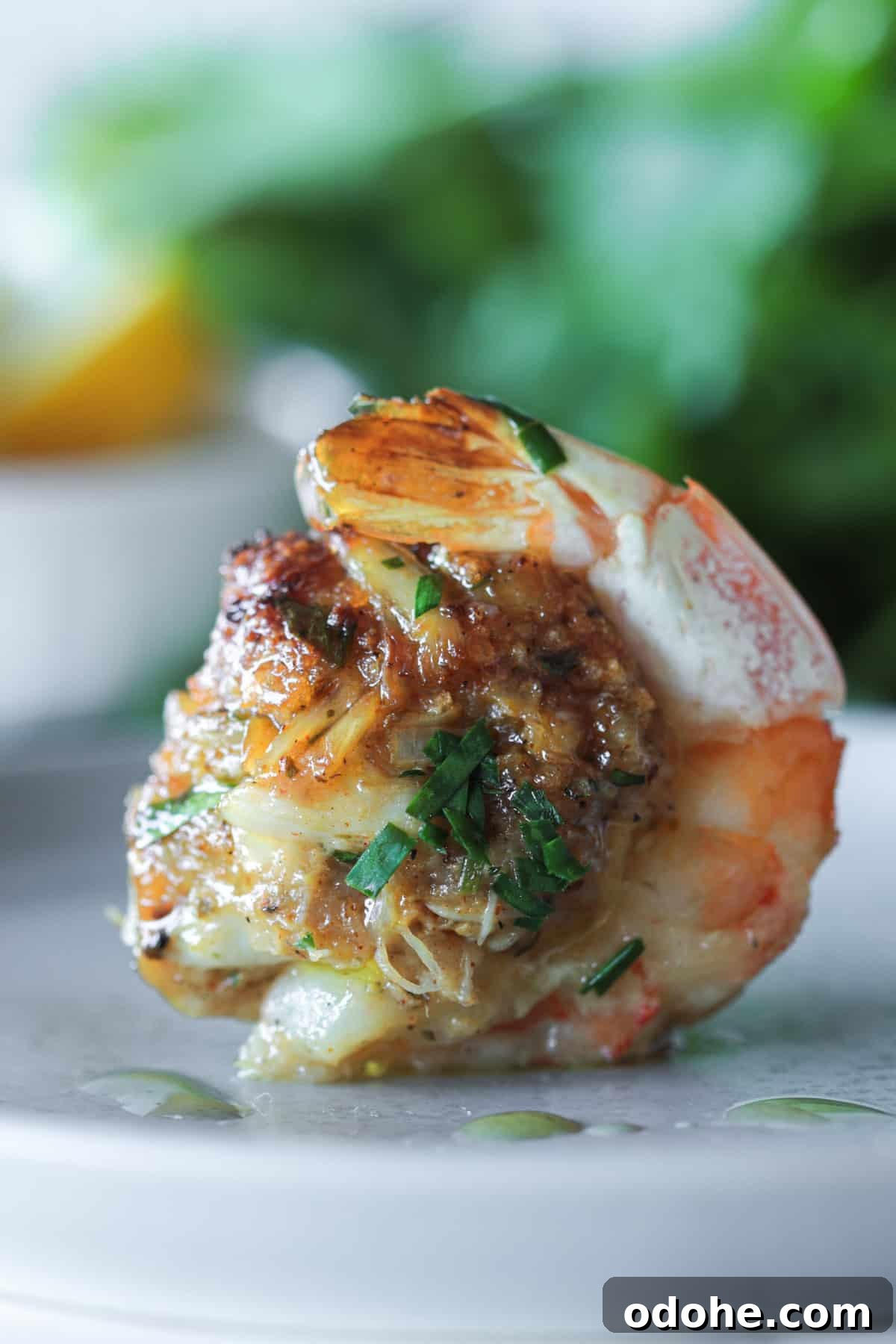 Stuffed shrimp with crab sitting on a plate.