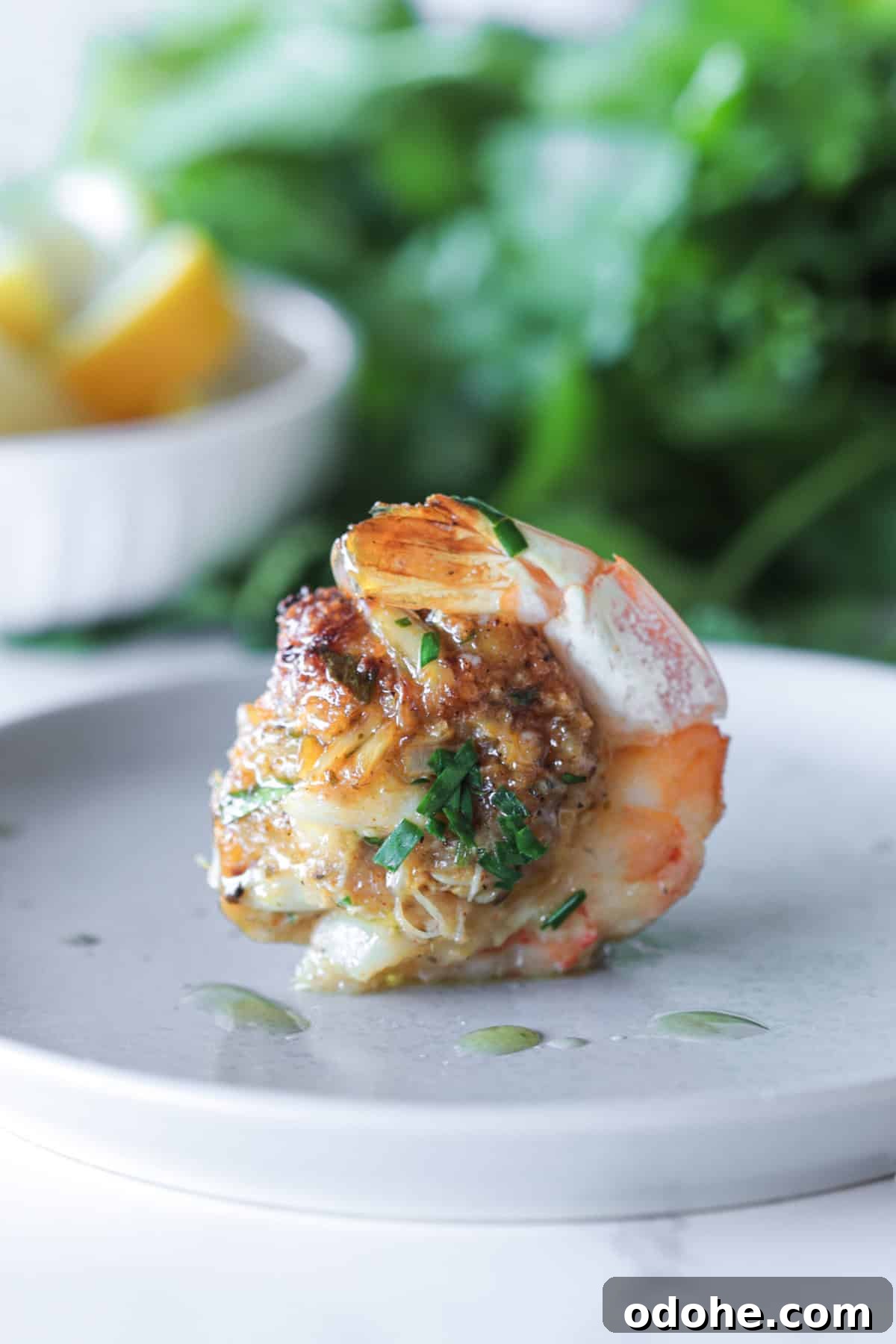 Finished stuffed shrimp on a plate.