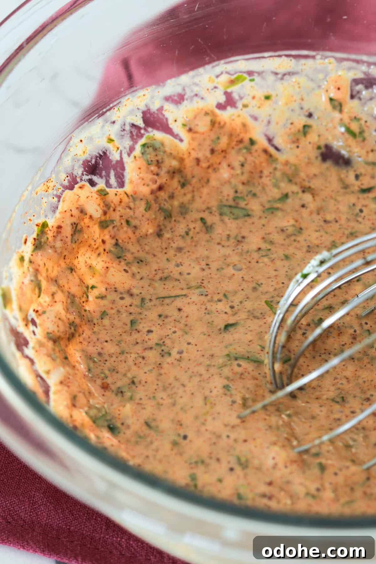 Bowl of mayo, seasoning, dijon and parsley in large bowl.