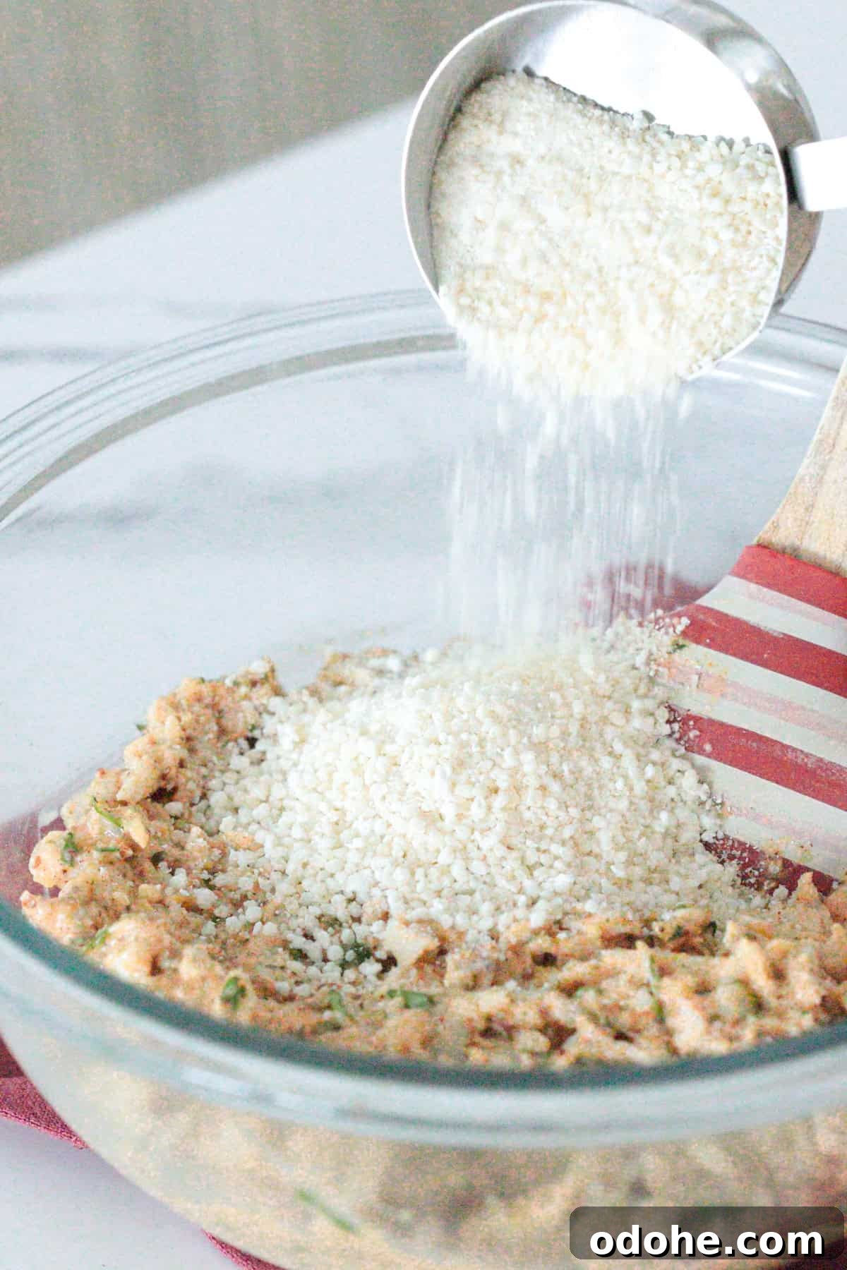 Adding breadcrumbs to bowl.