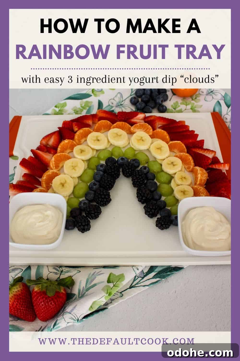 A fruit platter arranged in a rainbow pattern on a white serving tray, with yogurt dips on either side, against a white tile background with a decorative napkin, and text above reading "how to make a rainbow fruit tray with easy 3 ingredient yogurt dip clouds" and the website name below.