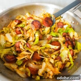 Southern fried cabbage with bacon, sausage, and onions, cooked until tender and full of Cajun flavor.