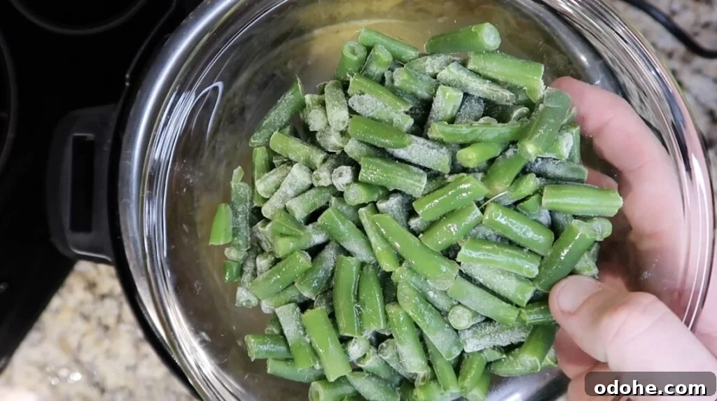 Adding green beans to pot