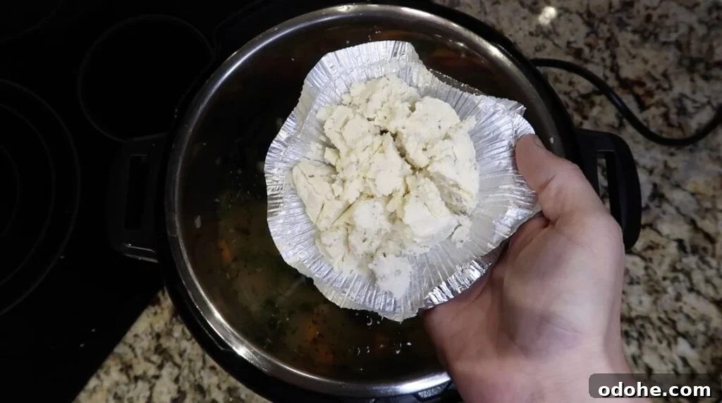 Adding herb cheese to soup