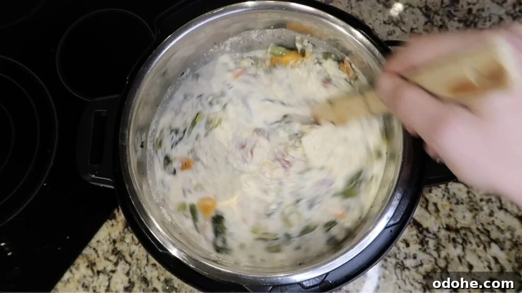 Stirring until dairy is combined with the soup