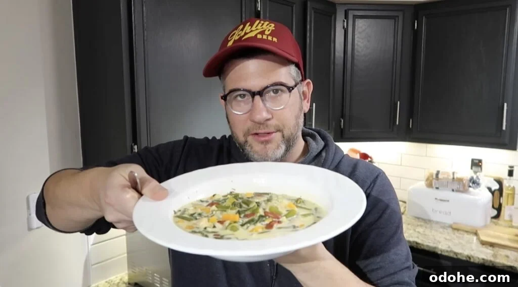 Man holding bowl of soup