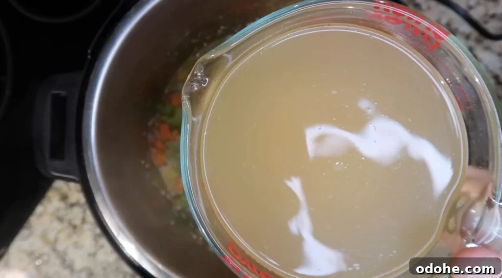 Adding broth to pot